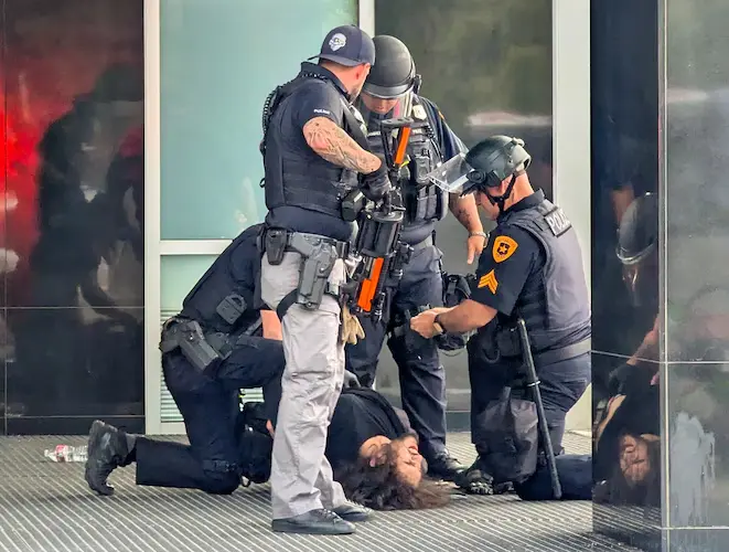 Salt Lake City Shooting During No Kings Protest: What We Know 1 A man is detained by City Police after the Salt Lake City shooting occurred during a rally on Saturday, June 14, 2025. (Image Credit: Chad Thaxton)