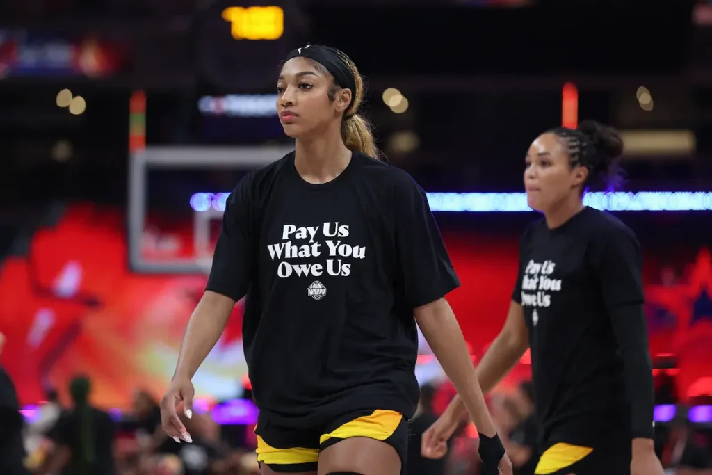 Angel Reese wearing the "Pay Us What You Owe Us" with her fellow WNBA all-stars at Saturday night's game. (Image Credit: Trevor Ruszkowski)